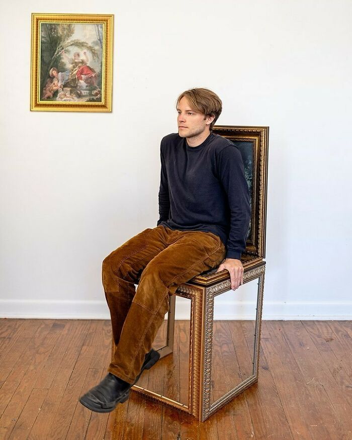 Man sitting on an unusual accessory by Nik Bentel, blending everyday objects with fashion in a creative setting.