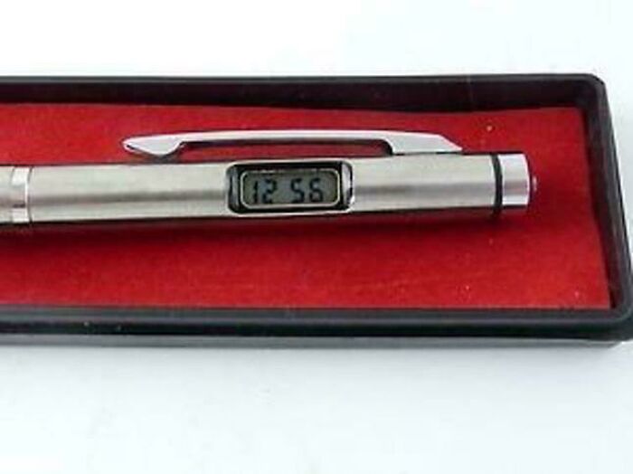 Digital wristwatch pen in a black case with red velvet lining, evoking nostalgic memories for older generations.