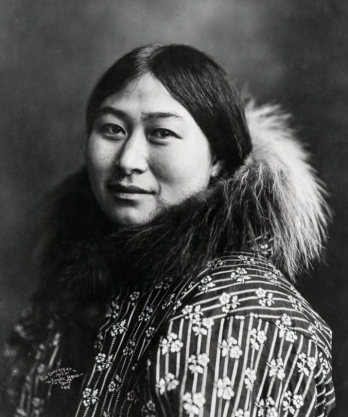 Portrait of an Inuit woman in traditional fur-lined clothing, showcasing the historic resilience of the Inuit people.