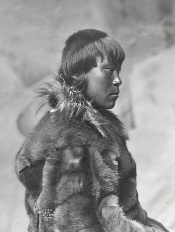 Profile portrait of an Inuit wearing traditional fur clothing, showcasing the historic resilience of the Inuit people.