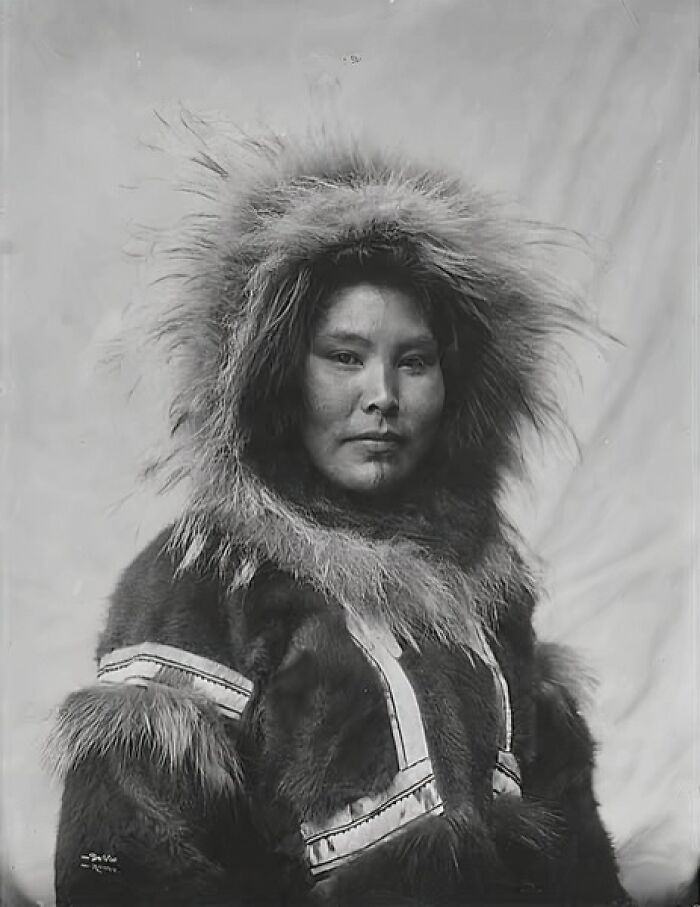 Historic photo of an Inuit woman wearing traditional fur clothing, reflecting the unbreakable spirit of the Inuit culture.