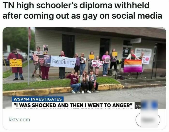 Group of people holding protest signs outside building, related to headlines that could pass for satire but are true.