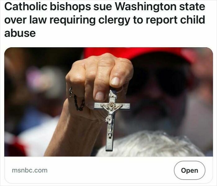 Hand holding a crucifix, illustrating a headline about Catholic bishops and clergy reporting laws from satire headlines.
