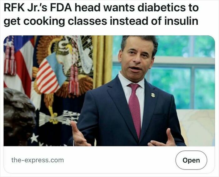 Man in suit speaking with American flags in background, illustrating headlines that could pass for satire but are true.