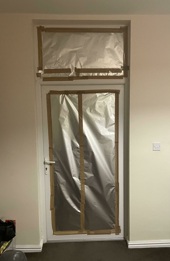 Puerta cubierta con papel aluminio y cinta para bloquear el calor, ejemplo de las consecuencias de olas de calor veraniegas.