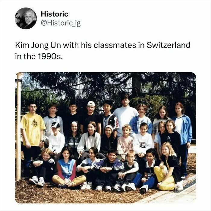 Historic photo of a school group from the 1990s, featuring classmates posing outdoors in casual clothing.