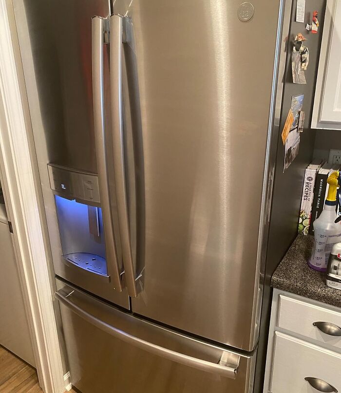 Stainless steel refrigerator with water dispenser in a kitchen showcasing clever finds under 20 dollars for daily annoyances.