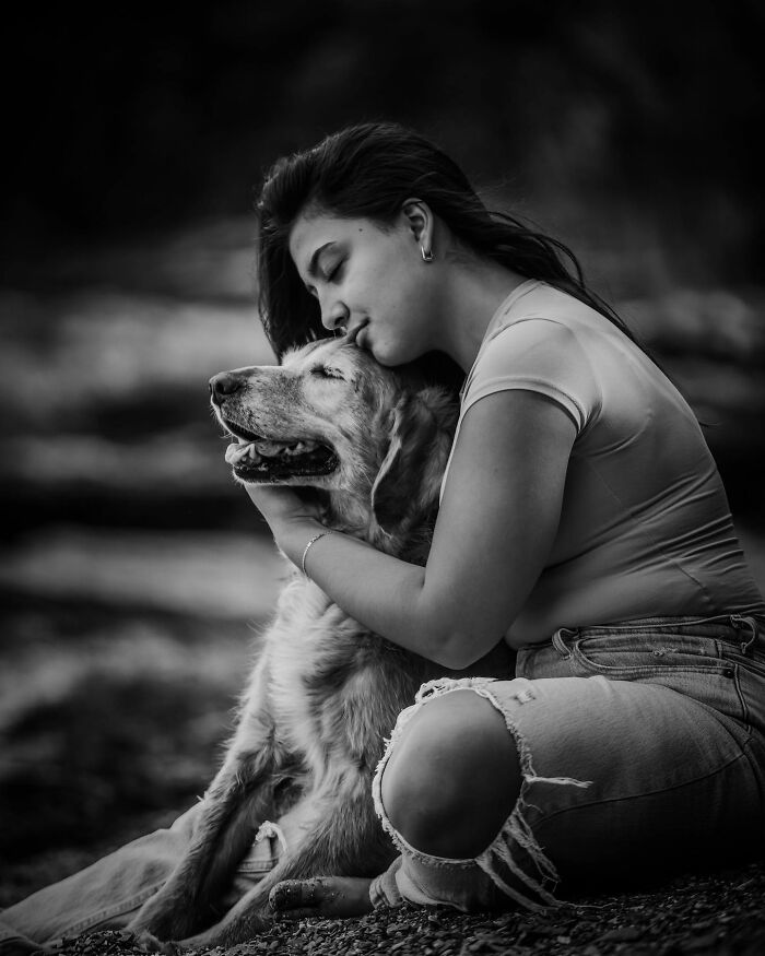 Young woman gently embracing her dog, a touching photo capturing the final moments between pets and their humans.