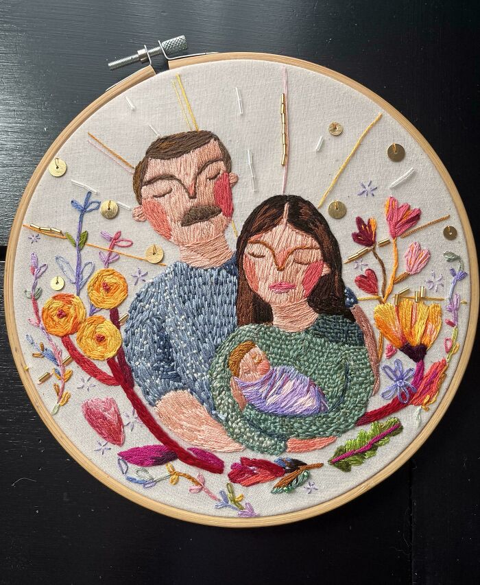 Embroidery art of a family holding a baby surrounded by colorful flowers, showcasing incredible and beautiful embroidery skills.