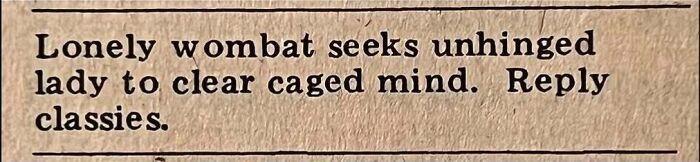 Vintage personals ad reading lonely wombat seeks unhinged lady to clear caged mind, illustrating romance and personals column.