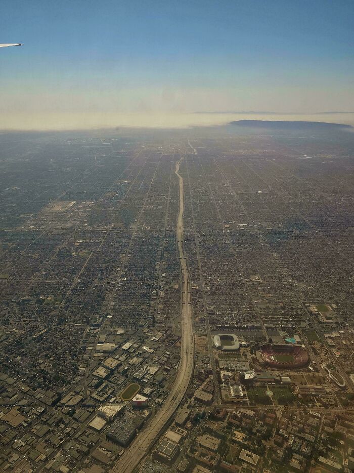 Aerial view of a sprawling urban area showing haze and dense development in the $58 billion ghost city.