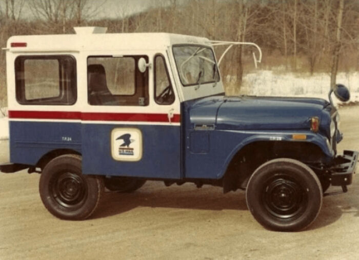 Vintage postal delivery vehicle parked outdoors, evoking nostalgia and reminding viewers of old age memories.