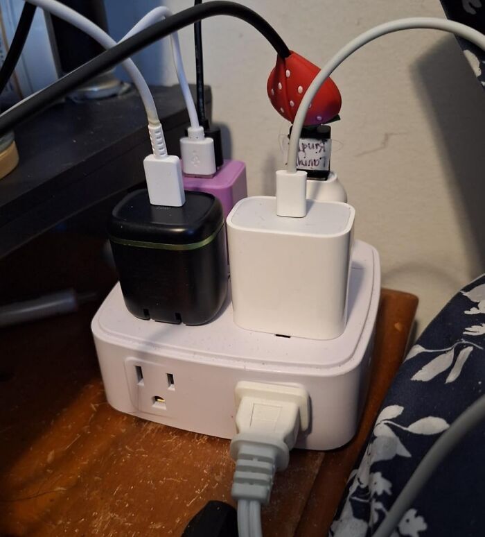 Power strip with multiple chargers and USB cables plugged in, essential dorm finds for surviving freshman year.