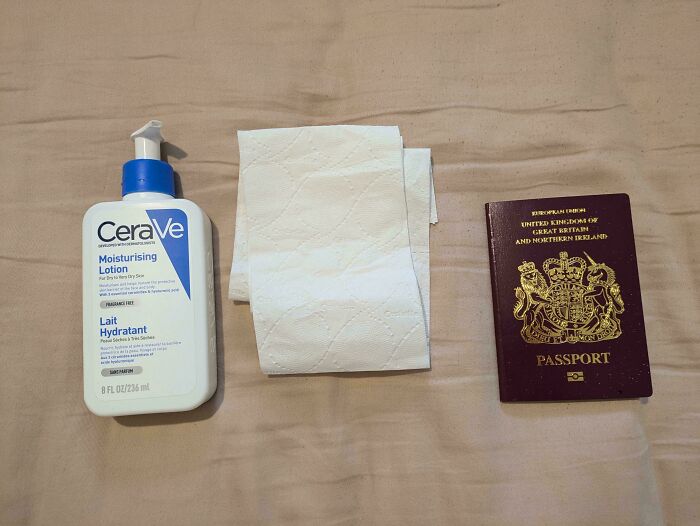 Moisturising lotion, toilet paper, and a UK passport laid out on a beige surface, representing chaotic British memes.