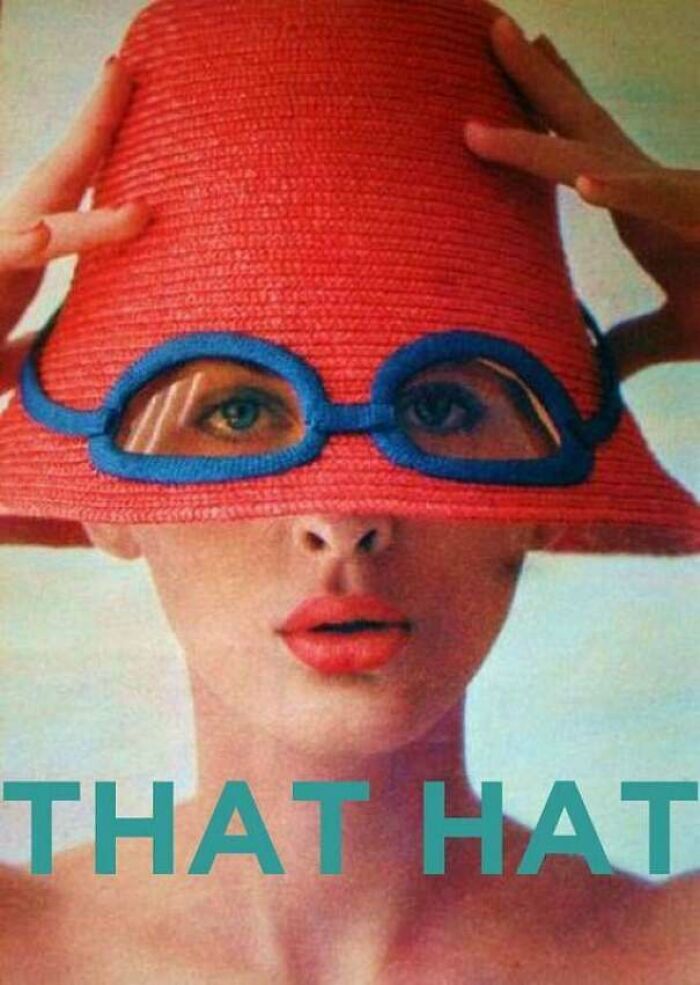 Woman wearing a red hat with integrated blue glasses, showcasing a funny example of awful taste but great e*******n.