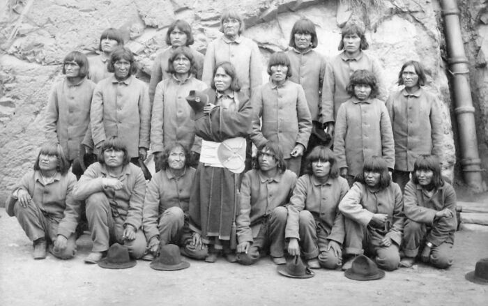 Black and white photo of inmates in uniform at Alcatraz, offering a rare glimpse into the harsh reality of prison life.