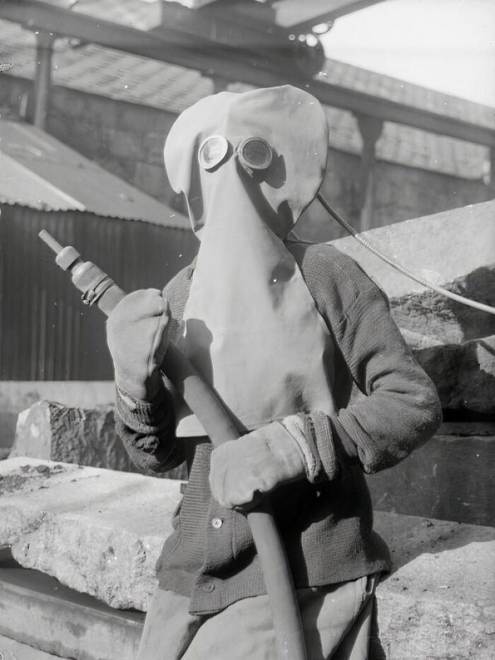 Woman wearing protective mask and gloves while working during WWI, showcasing how women changed everything during the war.