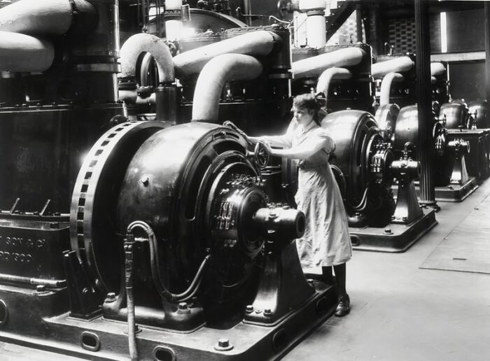 Woman operating large industrial machinery during WWI, highlighting how women changed everything in wartime industry.