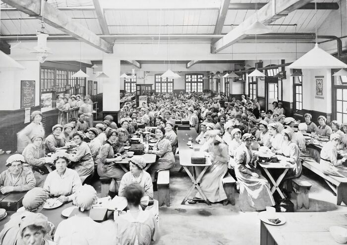 Large group of women workers gathered in a factory cafeteria during WWI, illustrating how women changed everything.