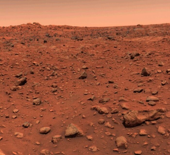 Rocky barren landscape under an orange sky representing the triumph and tragedy of the 20th century important images.