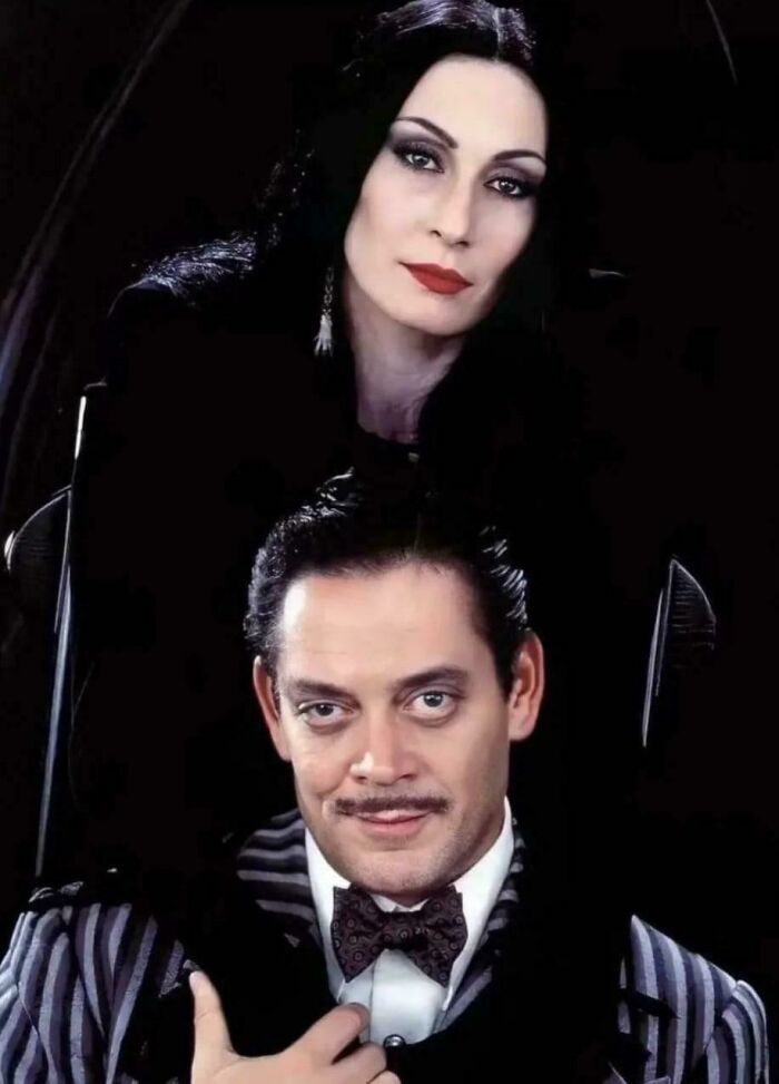 90s nostalgic Addams Family portrait with Morticia and Gomez Addams