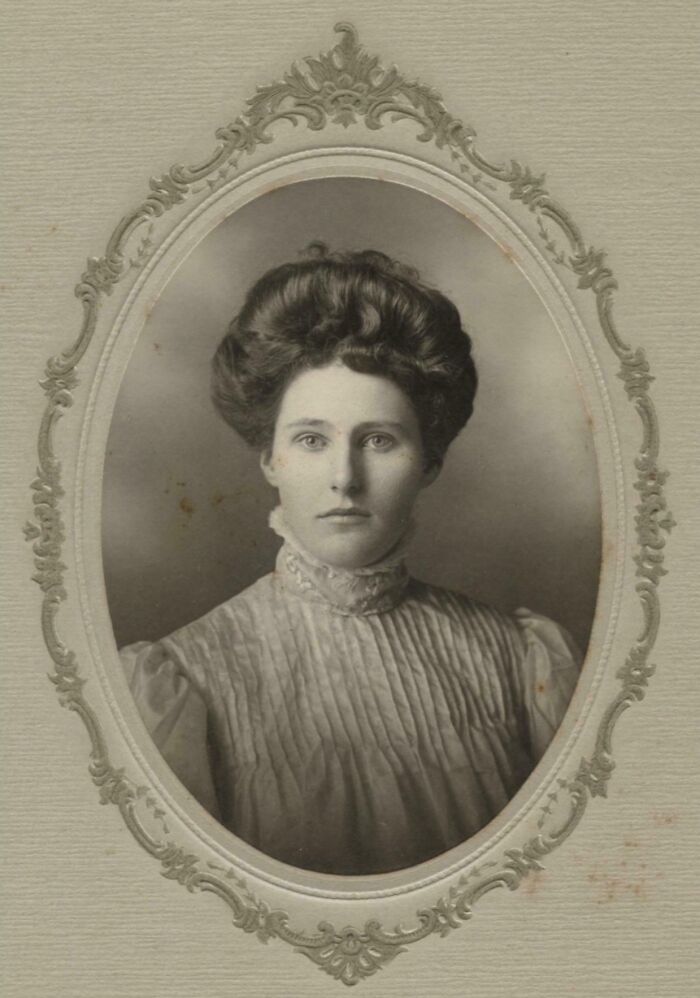 Vintage portrait of a woman in an ornate frame, showcasing candid glimpses into the past with historical details.