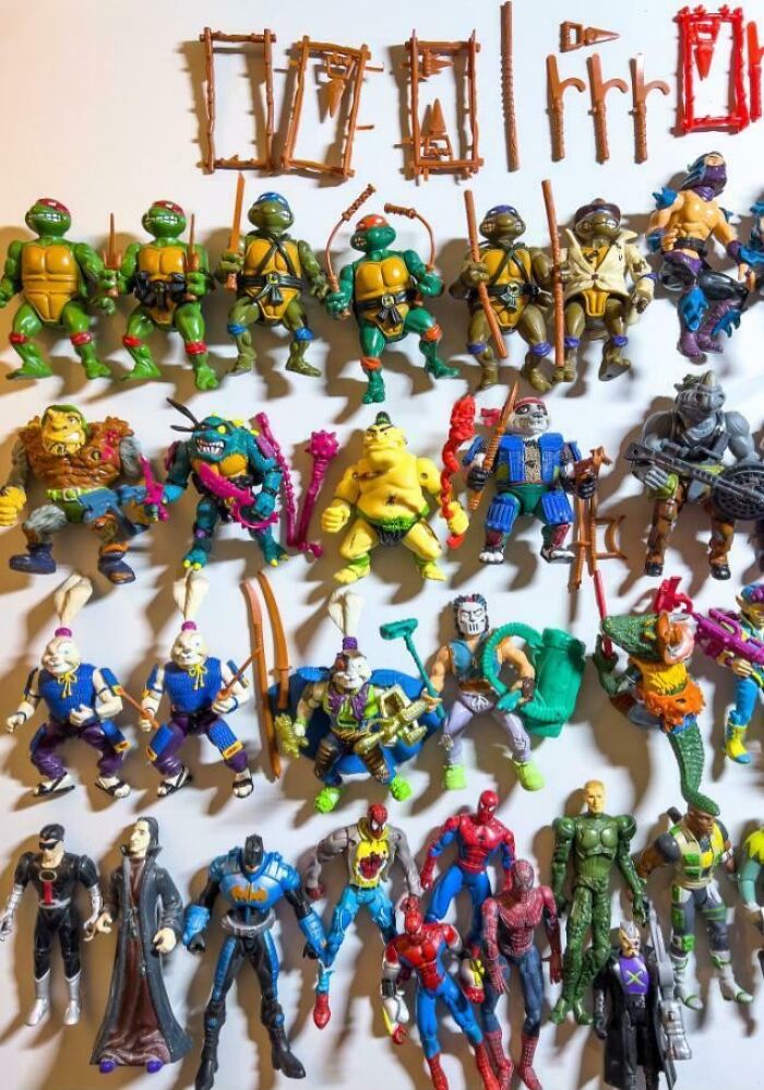 Collection of 90s action figures including Teenage Mutant Ninja Turtles and various comic book characters evoking nostalgic 90s memories.