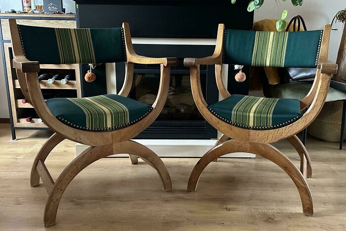 Pair of vintage wooden thrift store finds with green striped upholstery displayed in a modern living room setting.