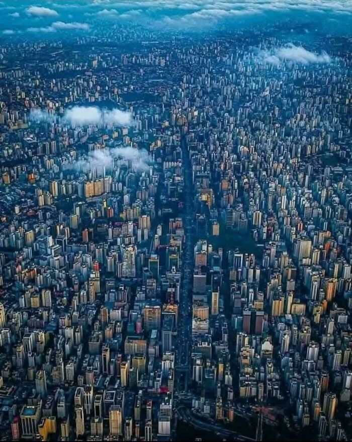 Aerial view of a densely packed cityscape in a $58 billion ghost city revealing urban sprawl and modern life costs.