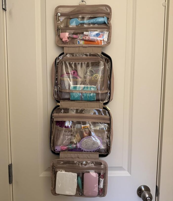 Hanging toiletry organizer with clear compartments packed with grooming and skincare items trending on Amazon this week.