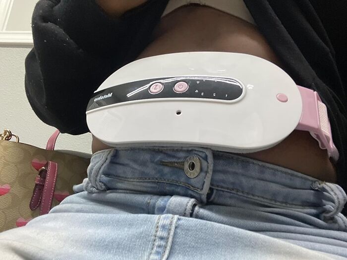 Abdominal muscle stimulator device worn on waist demonstrating trending Amazon add to cart worthy finds.