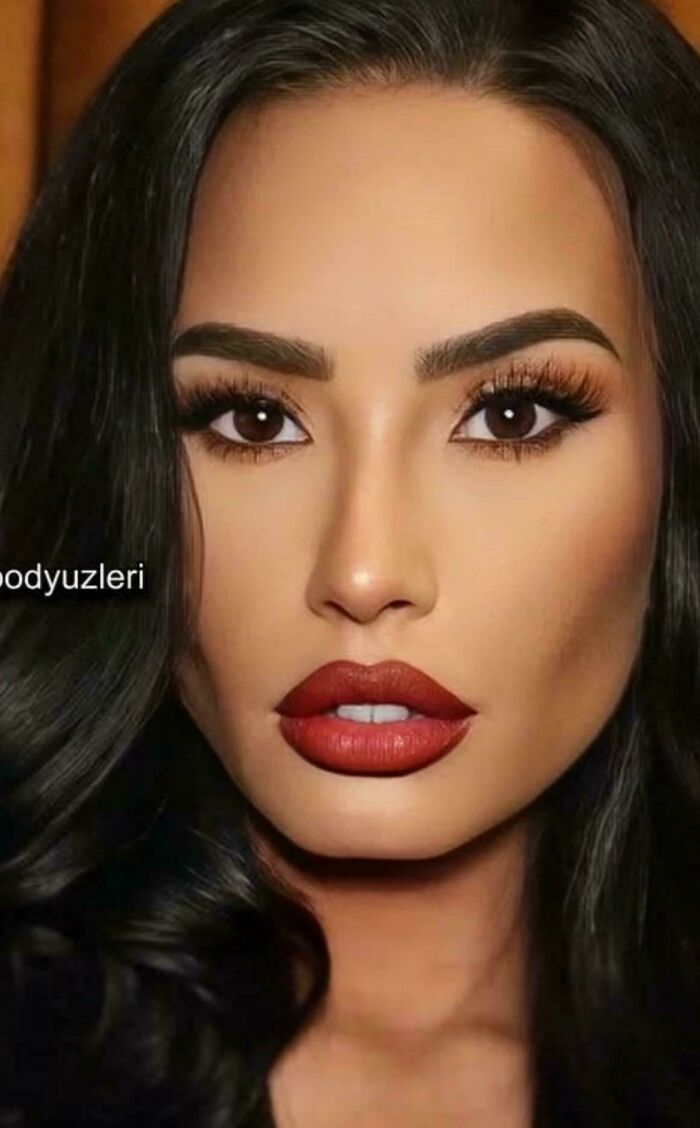 Close-up of a woman with bold makeup, showcasing Instagram vs reality moments behind the glam look.