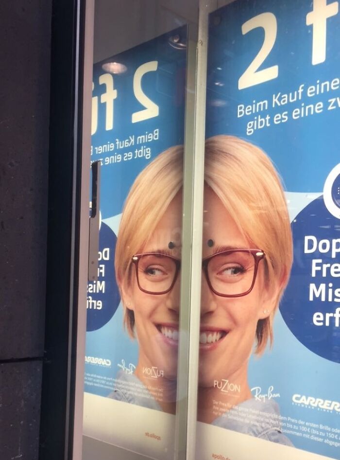 Reflection splits a smiling woman’s face in an advertising poster showing another unattainable body in advertising fails.