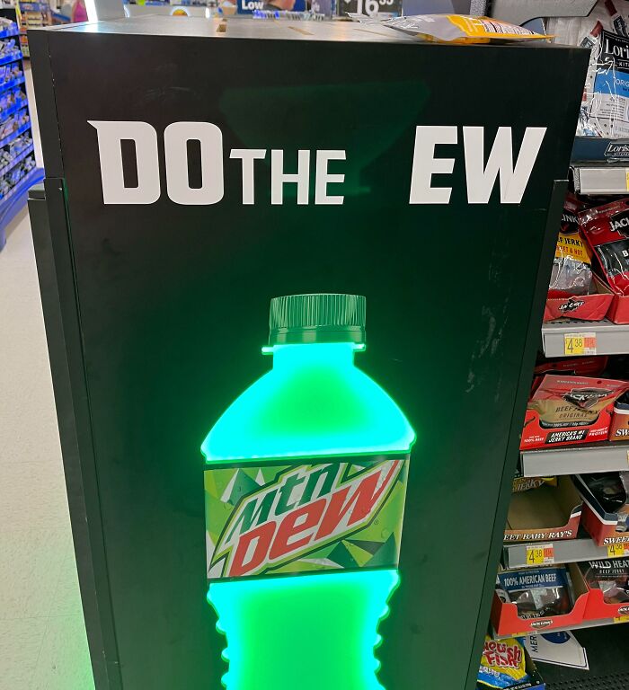 Mountain Dew bottle glowing with the incomplete phrase do the ew, a funny advertising fail display in a store aisle.