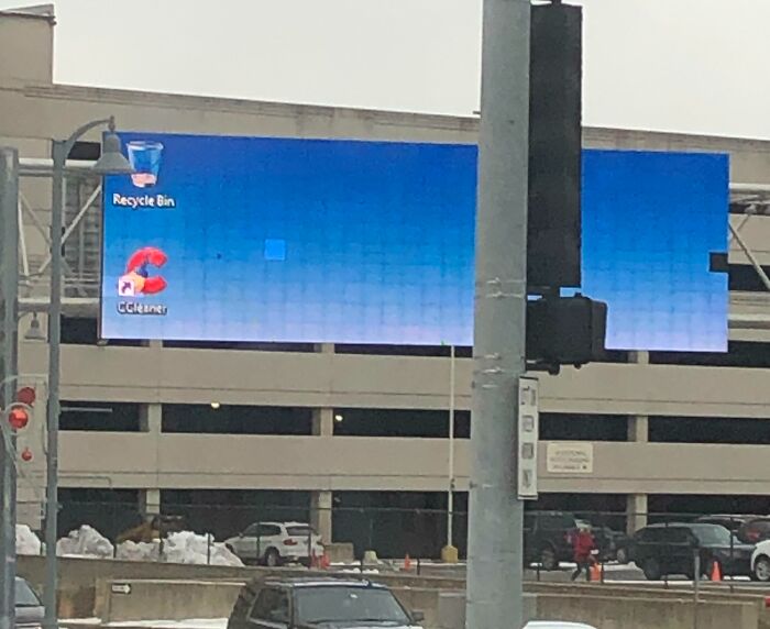 Digital billboard showing a computer desktop with recycle bin and CCleaner icon, illustrating a funny advertising fail.