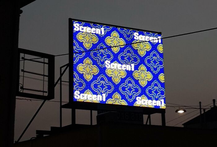 LED advertising screen showing a colorful pattern with the word screen repeated, illustrating funny advertising fails.
