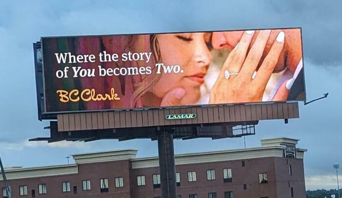 Billboard showing a close-up of a couple with the tagline where the story of you becomes two, illustrating an advertising fail.