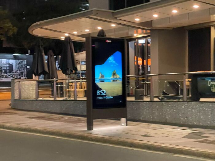 Digital advertising display on a sidewalk at night, highlighting an unattainable body portrayal in advertising fails.