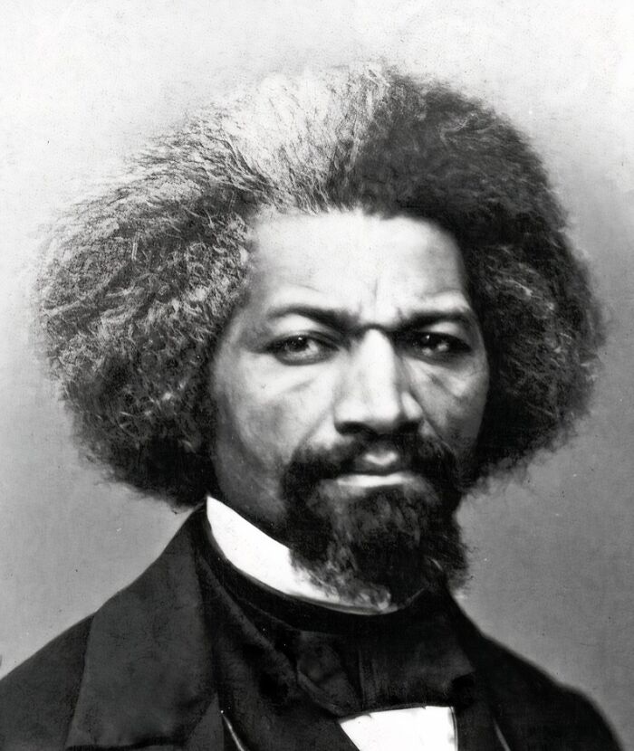 Black and white 19th century photo of a man with a beard and voluminous hair, showcasing invaluable historical moments.