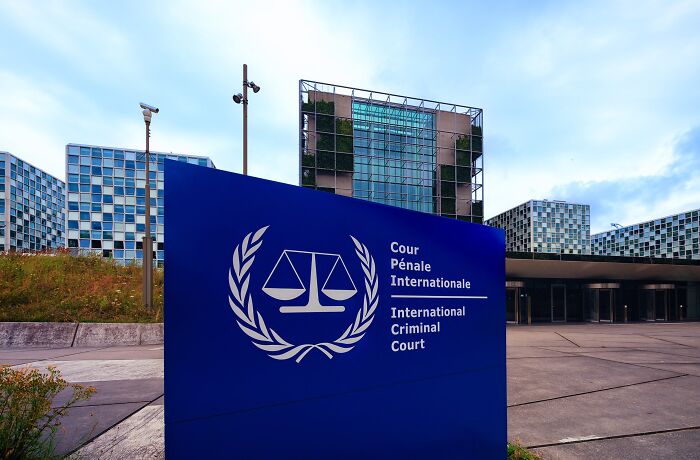 International Criminal Court building with blue signage featuring justice scales, reflecting major headlines that rocked the world in 2025.