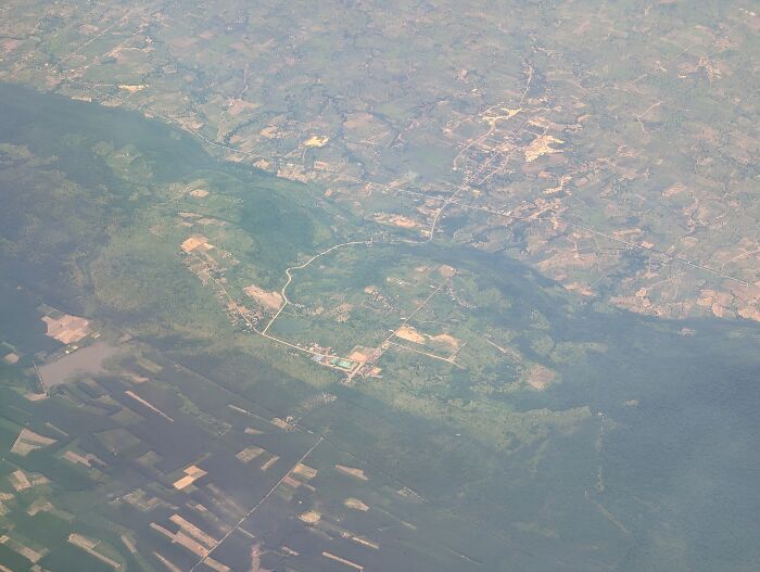 Aerial view of a rural landscape showcasing farmland and natural greenery, highlighting headlines that rocked the world in 2025.