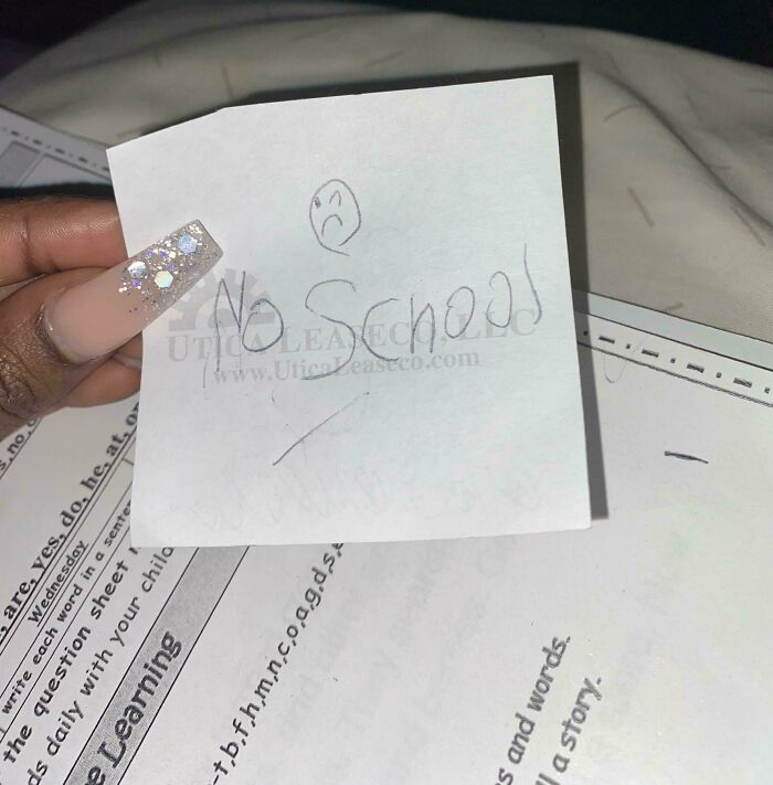 Hand holding a handwritten note saying No School with a sad face, showing a funny way people learned their lesson.