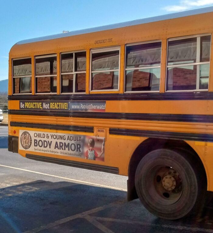 School bus with advertisement for child and young adult body armor, highlighting concerns that make you wonder if we’ve crossed point of no return.