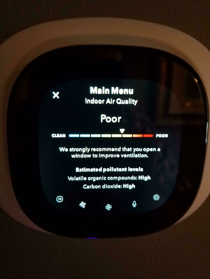 Air quality monitor displaying poor indoor air quality with high pollutant levels and ventilation recommendation.