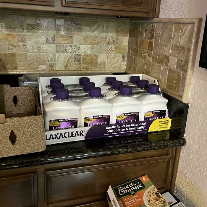 Multiple bottles of laxative on a kitchen counter, illustrating funny ways people learned their lesson with constipation relief.