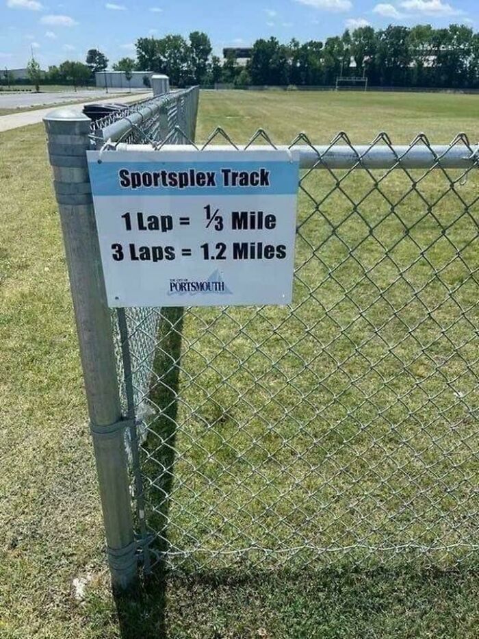 Sign on sportsplex track showing incorrect lap distance measurements, a funny way people learned their lesson about math errors.