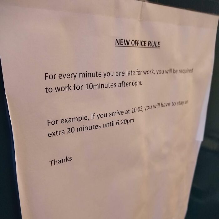 Office rule sign explaining penalty time for being late, reflecting photos that make you wonder if we've crossed the point of no return.
