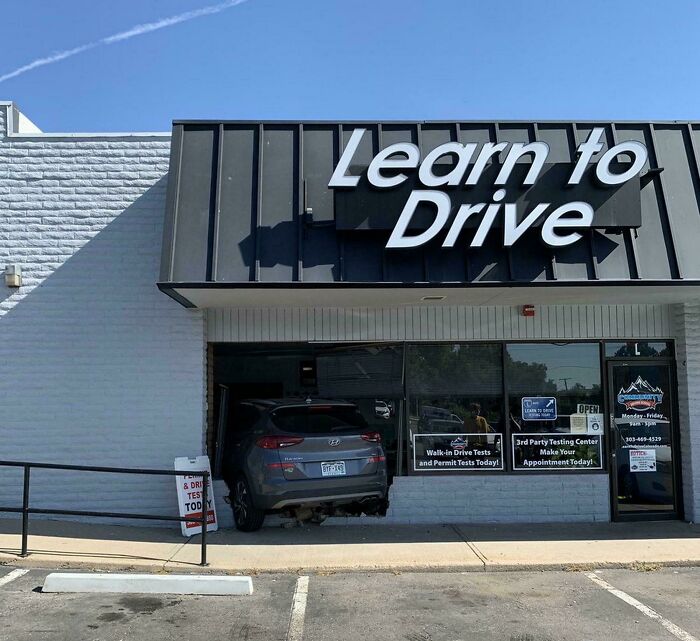 Car crashed into driving school building with Learn to Drive sign, a funny way people learned their lesson about driving.