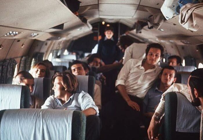Passengers seated and standing inside an airplane cabin in a photo taken before disaster struck.