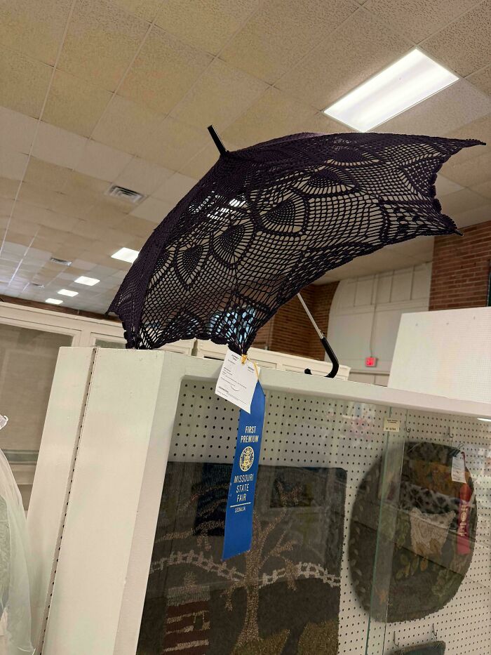 Crocheted black lace umbrella displayed at Missouri State Fair with first premium blue ribbon award.